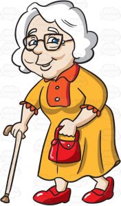 An old woman with white hair, wearing a black rimmed eye glasses, yellow with orange dress, red shoes and bag on her left hand, smiles while walking, with the help of her cream colored cane